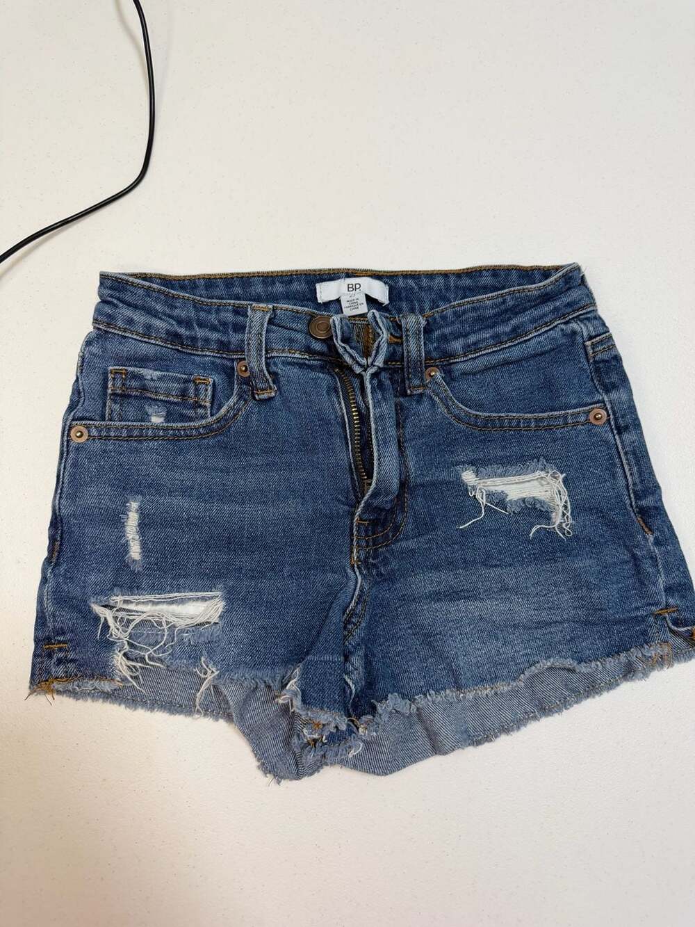 BP. High Rise Distressed Denim Shorts with Raw Hem